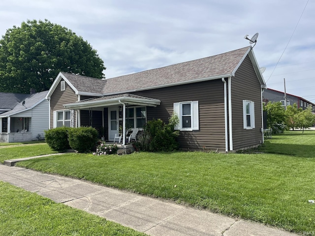 502 W Vantrees St, Washington, IN 47501 - view of front of property featuring a shingled roof, covered porch, and a front yard