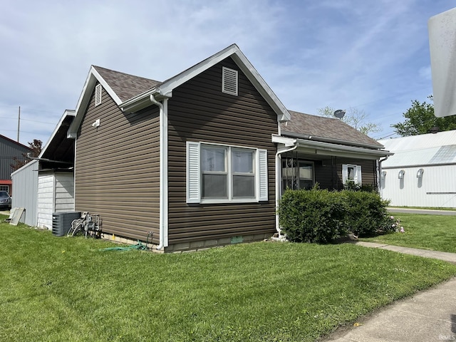 502 W Vantrees St, Washington, IN 47501 - view of side of home with a shingled roof, a lawn, and cooling unit