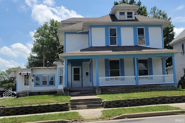 american foursquare style home featuring a porch and a front lawn