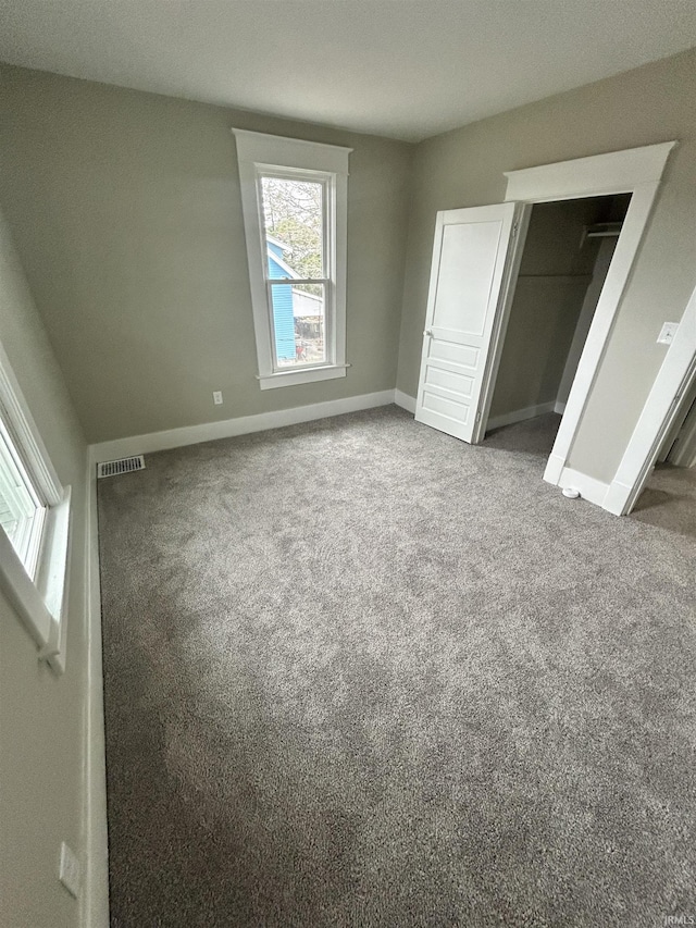 unfurnished bedroom featuring carpet flooring and baseboards
