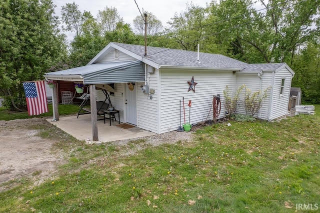 902 E Grant, Hartford City, IN 47348 - back of property with a patio area, roof with shingles, and a yard
