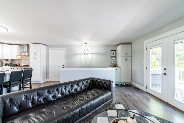 living area with wood finished floors and baseboards