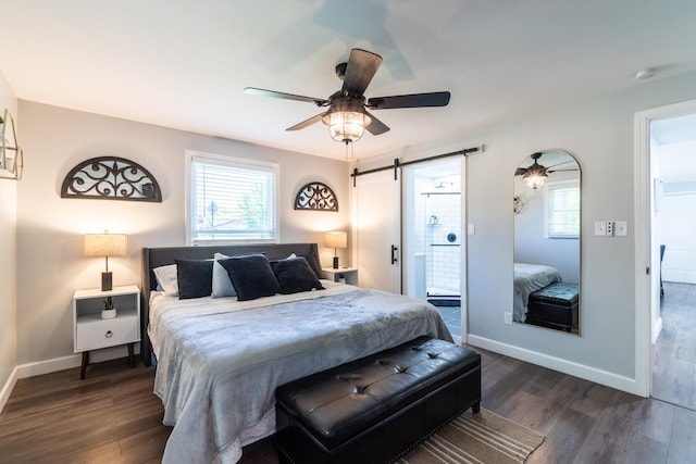 bedroom featuring a barn door, dark wood-type flooring, baseboards, and ceiling fan