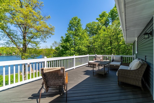 wooden terrace with an outdoor hangout area and a water view