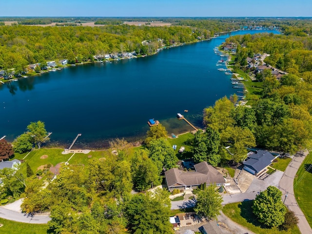 bird's eye view of a nearby body of water and a heavily wooded area