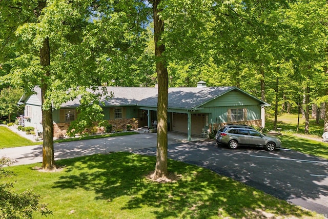410 Longtree Ln, Logansport, IN 46947 - single story home with driveway, a garage, a front lawn, and a chimney