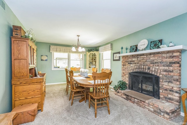 410 Longtree Ln, Logansport, IN 46947 - dining space featuring light colored carpet, a chandelier, baseboards, and a fireplace