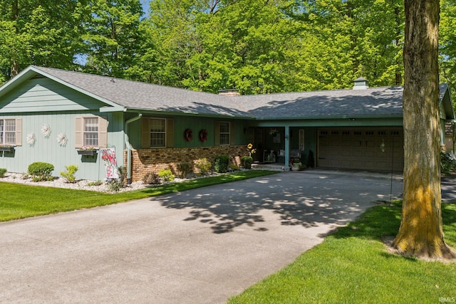 410 Longtree Ln, Logansport, IN 46947 - single story home with a garage, a chimney, driveway, a shingled roof, and brick siding
