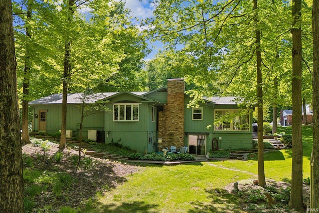 410 Longtree Ln, Logansport, IN 46947 - rear view of house featuring a chimney and a yard