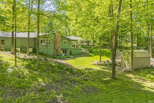 410 Longtree Ln, Logansport, IN 46947 - view of grassy yard with a storage shed and an outdoor structure