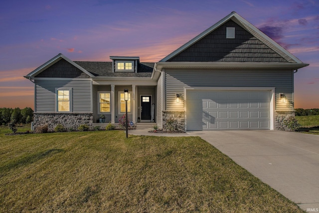 craftsman house with stone siding, concrete driveway, a yard, and a garage