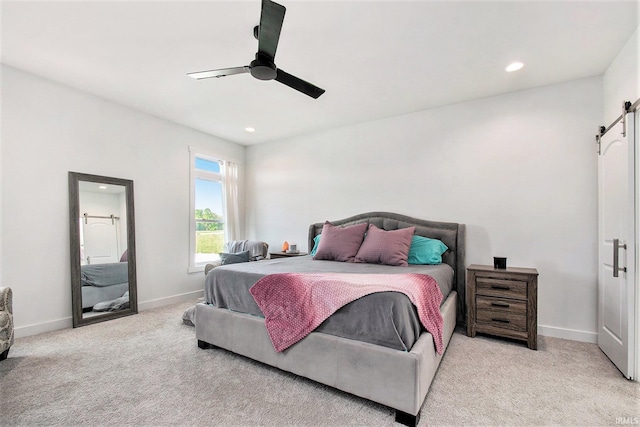 carpeted bedroom with a barn door, baseboards, recessed lighting, and a ceiling fan
