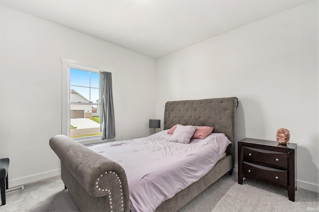 bedroom featuring carpet floors and baseboards