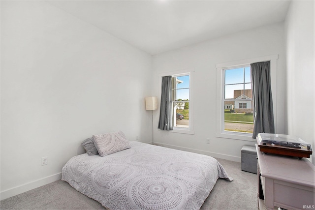 bedroom featuring carpet and baseboards