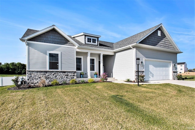 craftsman-style house with stone siding, driveway, and a front yard