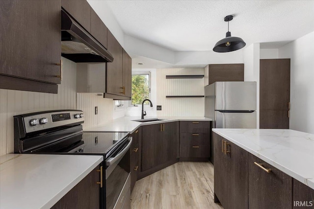 214 Mccutcheon Dr, Lafayette, IN 47909 - kitchen with stainless steel appliances, under cabinet range hood, light wood-style flooring, dark brown cabinetry, and a sink