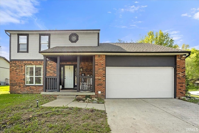 214 Mccutcheon Dr, Lafayette, IN 47909 - traditional-style home featuring brick siding, an attached garage, driveway, and covered porch