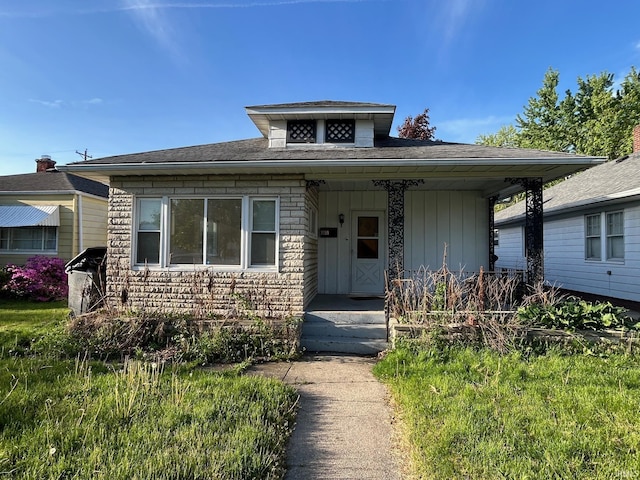bungalow-style house featuring board and batten siding, roof with shingles, and a porch