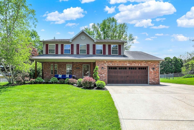 4113 S Hedgewood Ct, Bloomington, IN 47403 - view of front facade featuring driveway, brick siding, covered porch, and an attached garage