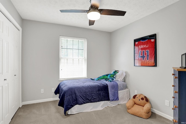 4113 S Hedgewood Ct, Bloomington, IN 47403 - carpeted bedroom featuring a closet, baseboards, a textured ceiling, and a ceiling fan