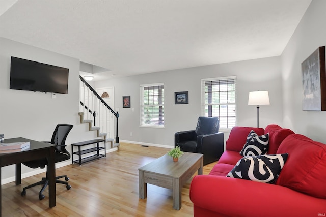 4113 S Hedgewood Ct, Bloomington, IN 47403 - living area featuring light wood-style flooring, stairway, baseboards, and a desk
