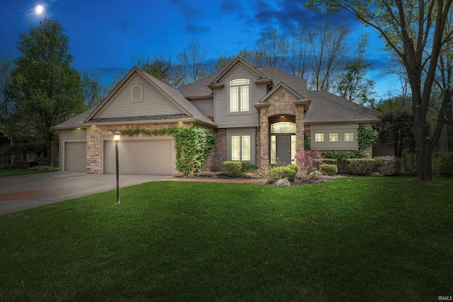 23306 Bluff Crest Dr, Elkhart, IN 46516 - view of front facade with stone siding, an attached garage, a front lawn, concrete driveway, and a shingled roof