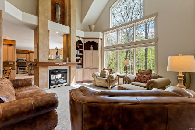 23306 Bluff Crest Dr, Elkhart, IN 46516 - living room featuring a towering ceiling, light carpet, healthy amount of natural light, a fireplace, and built in shelves