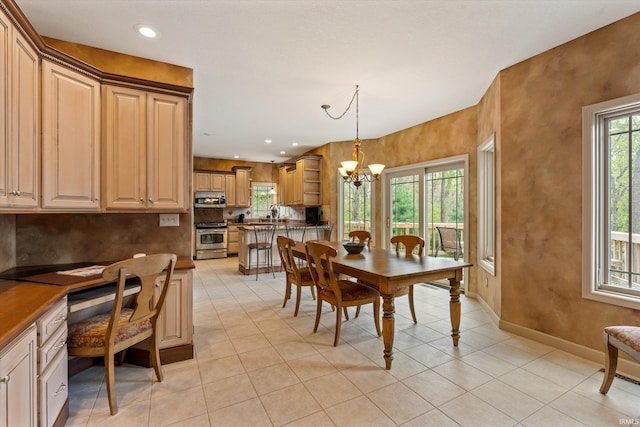 23306 Bluff Crest Dr, Elkhart, IN 46516 - dining area with a chandelier, light tile patterned floors, recessed lighting, and baseboards