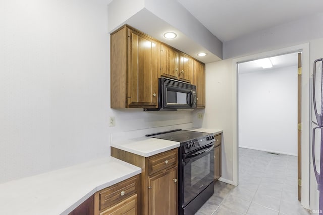 3400 W Riggin Rd Unit 6, Muncie, IN 47304 - kitchen with black appliances, light countertops, brown cabinetry, recessed lighting, and light tile patterned floors