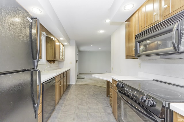 3400 W Riggin Rd Unit 6, Muncie, IN 47304 - kitchen featuring black appliances, a sink, brown cabinets, recessed lighting, and light countertops