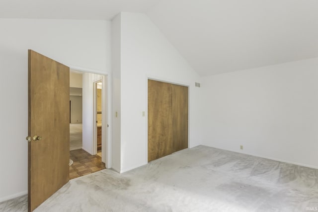 3400 W Riggin Rd Unit 6, Muncie, IN 47304 - unfurnished bedroom with high vaulted ceiling, carpet flooring, and a closet