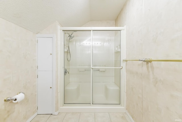 3400 W Riggin Rd Unit 6, Muncie, IN 47304 - full bathroom featuring tile patterned floors, a stall shower, lofted ceiling, and a textured ceiling