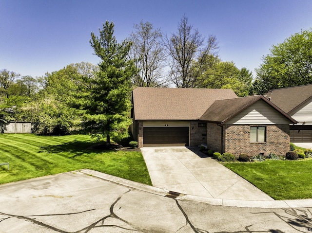 3400 W Riggin Rd Unit 6, Muncie, IN 47304 - view of front facade with brick siding, a front lawn, an attached garage, and driveway