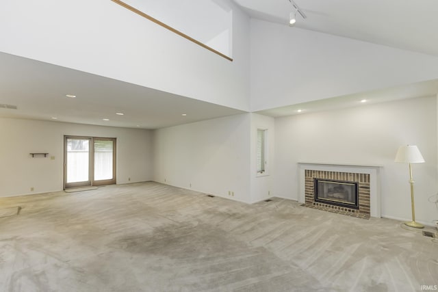 3400 W Riggin Rd Unit 6, Muncie, IN 47304 - unfurnished living room with light carpet, a fireplace, recessed lighting, a high ceiling, and track lighting