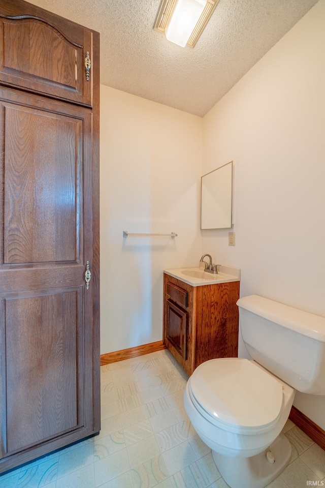 109 E Grant St, Lafontaine, IN 46940 - bathroom with a textured ceiling, baseboards, toilet, and vanity