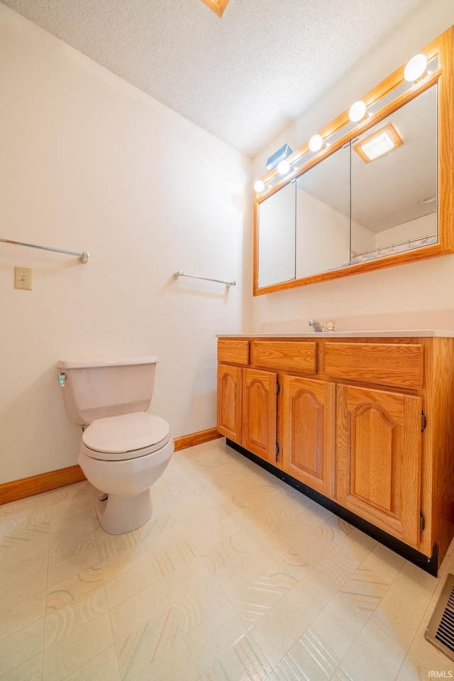 109 E Grant St, Lafontaine, IN 46940 - bathroom featuring baseboards, toilet, a textured ceiling, and vanity