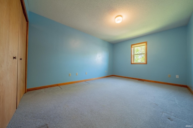 109 E Grant St, Lafontaine, IN 46940 - carpeted spare room featuring baseboards and a textured ceiling