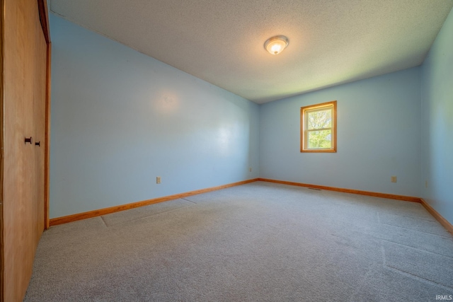 109 E Grant St, Lafontaine, IN 46940 - spare room featuring light carpet, baseboards, and a textured ceiling