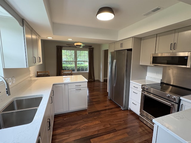 1643 W 1st St, Jasper, IN 47546 - kitchen with appliances with stainless steel finishes, a sink, dark wood-style floors, a peninsula, and recessed lighting