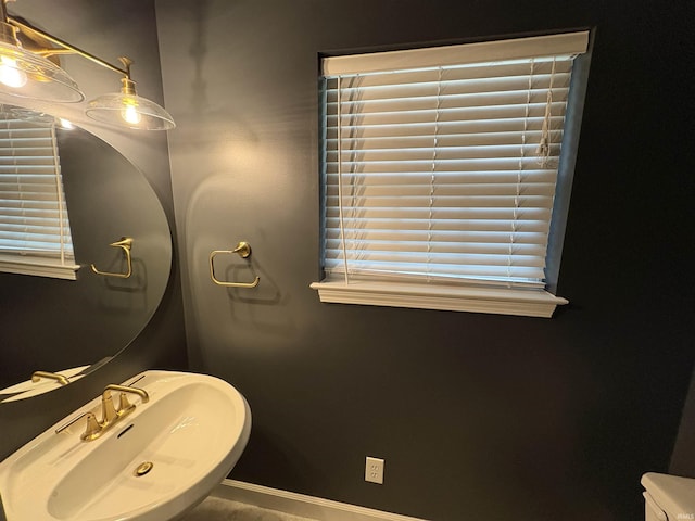 1643 W 1st St, Jasper, IN 47546 - bathroom with a sink, baseboards, and healthy amount of natural light