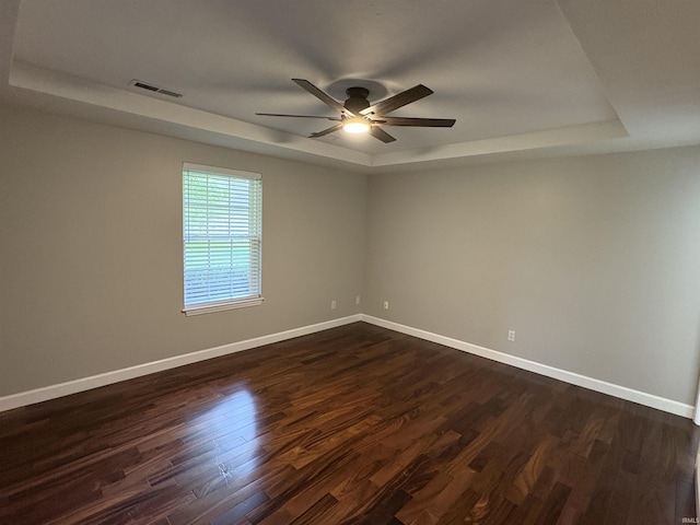 1643 W 1st St, Jasper, IN 47546 - empty room featuring a tray ceiling, a ceiling fan, dark wood-style floors, and baseboards