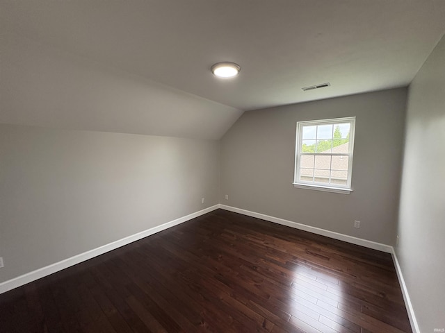 1643 W 1st St, Jasper, IN 47546 - bonus room featuring vaulted ceiling, dark wood-style flooring, and baseboards