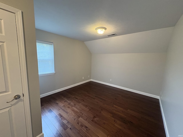 1643 W 1st St, Jasper, IN 47546 - additional living space featuring dark wood-style flooring, lofted ceiling, and baseboards