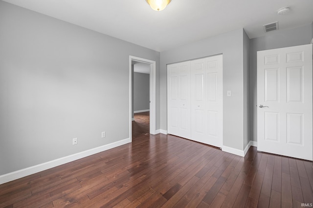 1643 W 1st St, Jasper, IN 47546 - unfurnished bedroom with baseboards, dark wood-style flooring, and a closet
