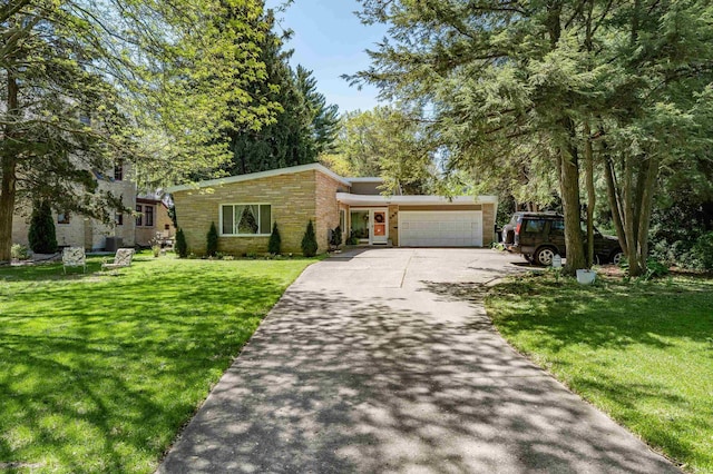 view of front of property with stone siding, asphalt driveway, a garage, and a front yard