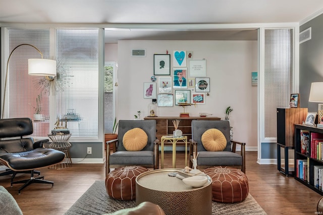 sitting room featuring wood finished floors, baseboards, and healthy amount of natural light