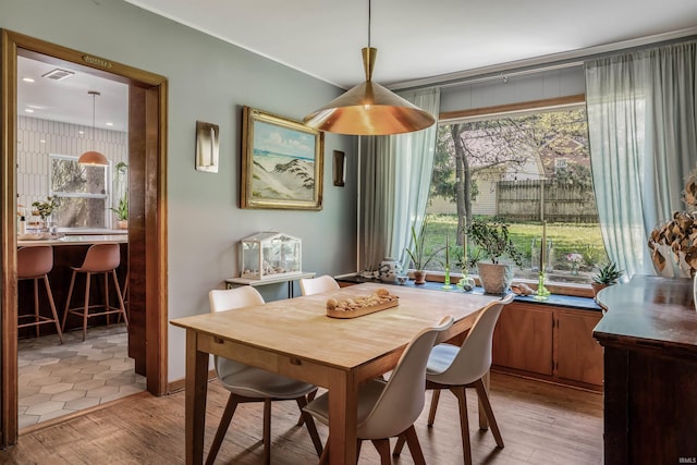 dining space featuring light wood finished floors