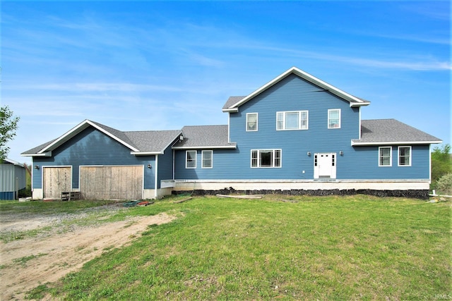 5025 N Elder Rd, Larwill, IN 46764 - rear view of house with a yard and roof with shingles