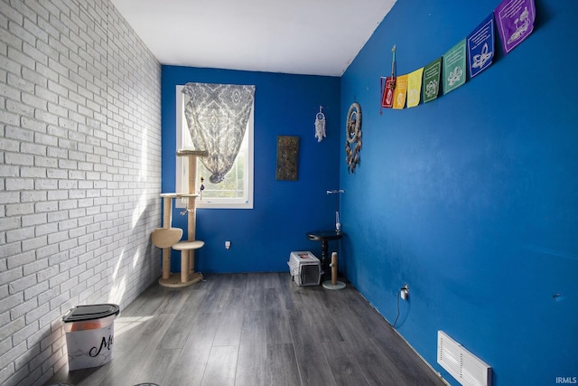 5025 N Elder Rd, Larwill, IN 46764 - empty room featuring wood finished floors and brick wall