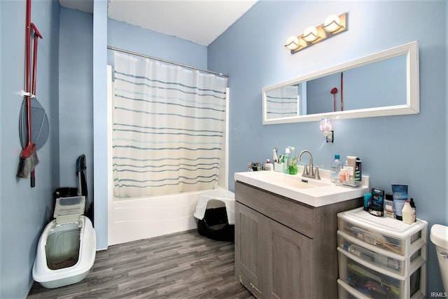 5025 N Elder Rd, Larwill, IN 46764 - full bath with toilet, wood finished floors, vanity, and shower / bath combo with shower curtain
